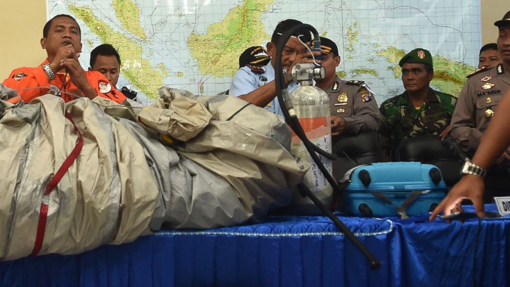 PHOTO: Members of the Indonesian air force show items retrieved from the Java sea during search and rescue operations for the missing AirAsia flight QZ8501, on Dec. 30, 2014. 