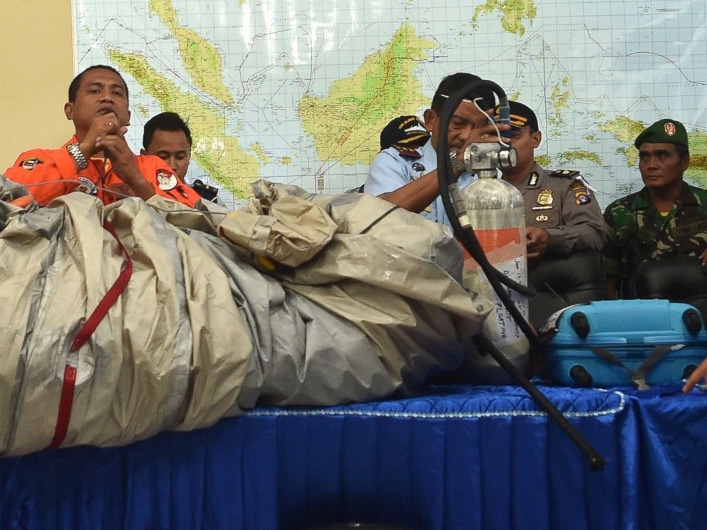 PHOTO: Members of the Indonesian air force show items retrieved from the Java sea during search and rescue operations for the missing AirAsia flight QZ8501, on Dec. 30, 2014.