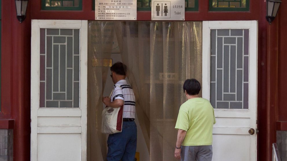 Men walk into a public toilet in Beijing, China on May 24, 2012.