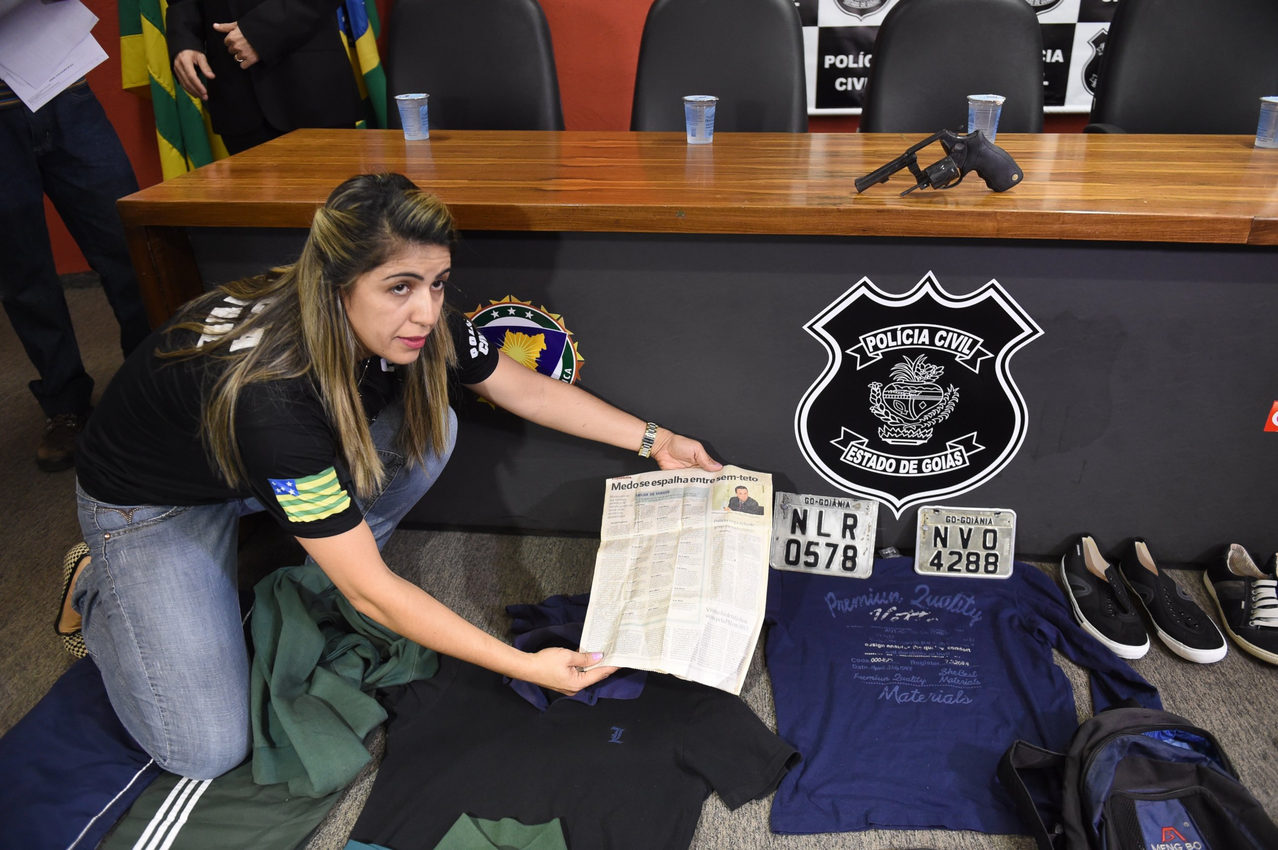 PHOTO: A police officer shows clothes, a gun, and other objects seized during the arrest of alleged serial killer Tiago Gomes da Rocha (not pictured), suspected of killing 39 people, at the Department of Security in Goiania, Brazil, Oct. 16, 2014. 