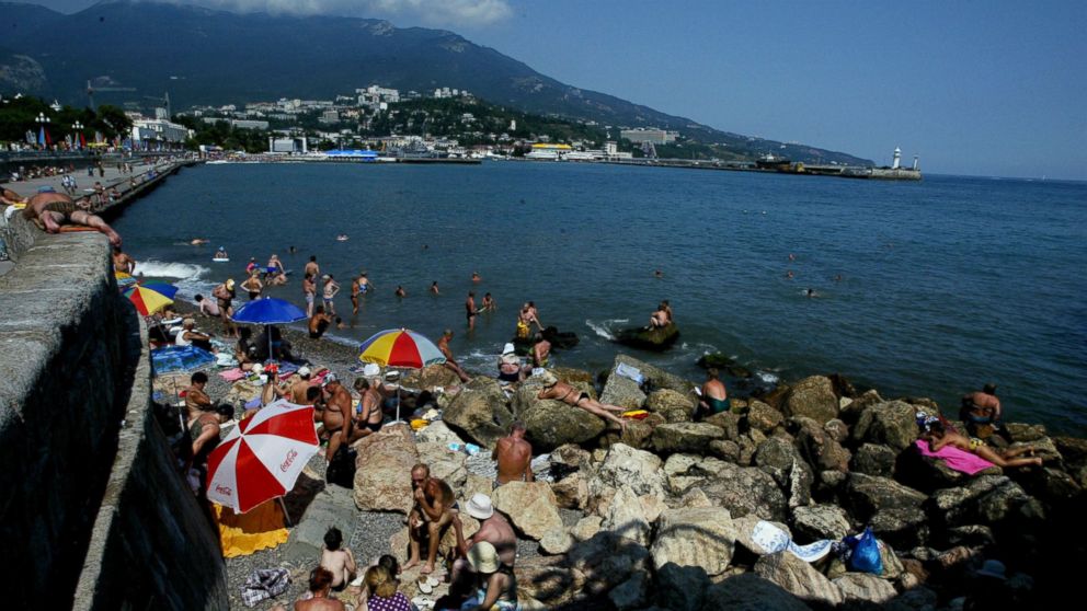 PHOTO: Sunbathers lay out on the rugged beach of Yalta in this August 18, 2003 file photo taken in Crimea.