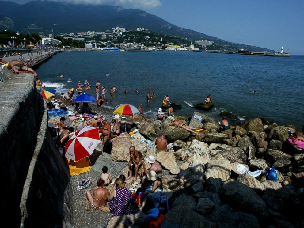 PHOTO: Sunbathers lay out on the rugged beach of Yalta in this August 18, 2003 file photo taken in Crimea.