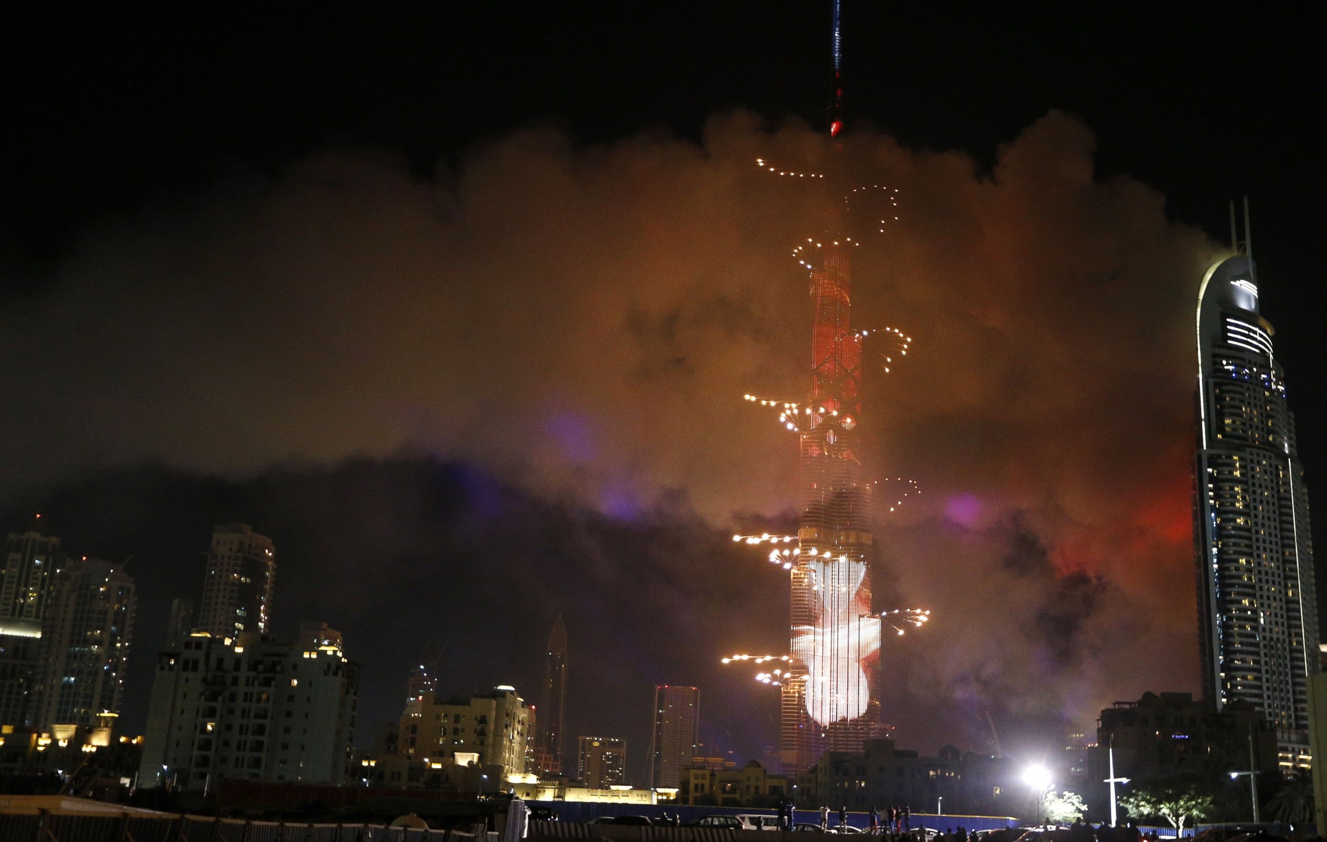 PHOTO: Smoke billows from a fire at the Address Downtown Hotel during a fireworks display at the Burj Khalifa, Jan. 1, 2016 in Dubai.