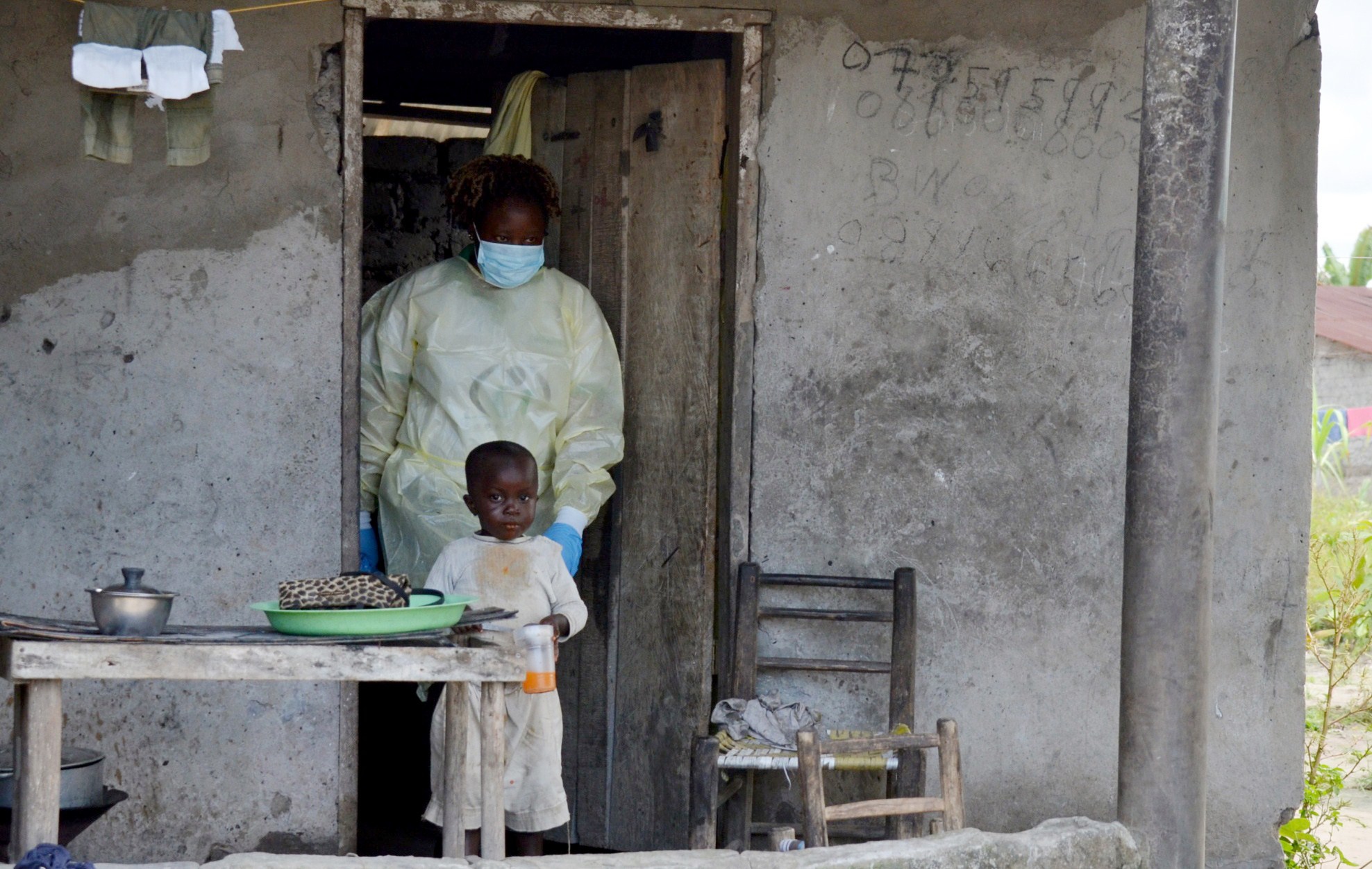 PHOTO: A member of the NGO U Fondation leaves a house after visiting quarantined family members suffering from the Ebola virus, on Oct. 16, 2014 in Monrovia, Liberia. 