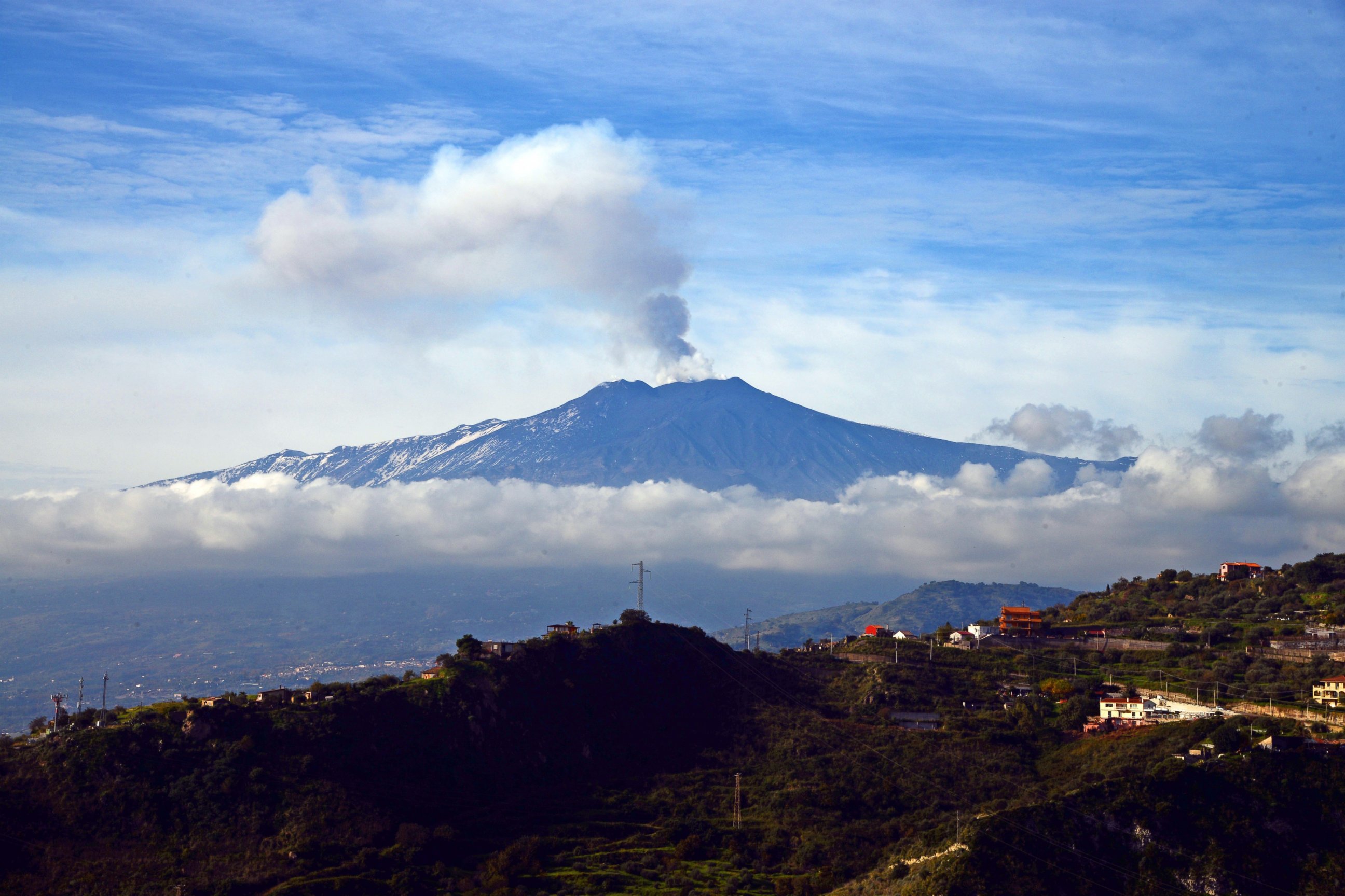 PHOTO: Smoke rises over the city of Taormina during an eruption of the Mount Etna, one of the most active volcanoes in the world, near Catania, on Dec. 4, 2015.