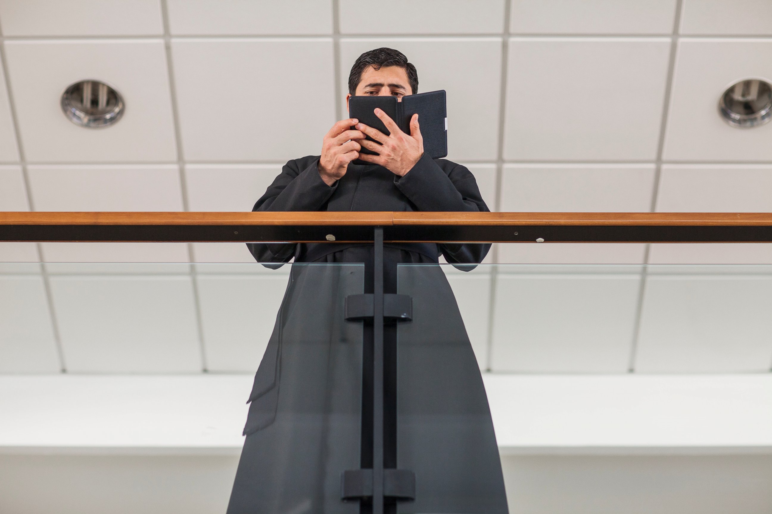 PHOTO: A priest who is a student of the Pontifical Athenaeum Regina Apostolorum reads the Bible during class break while the Exorcism and Prayer of Liberation annual conference is taking place on May 5, 2014 in Rome. Italy