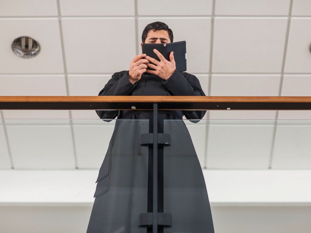 PHOTO: A priest who is a student of the Pontifical Athenaeum Regina Apostolorum reads the Bible during class break while the Exorcism and Prayer of Liberation annual conference is taking place on May 5, 2014 in Rome. Italy