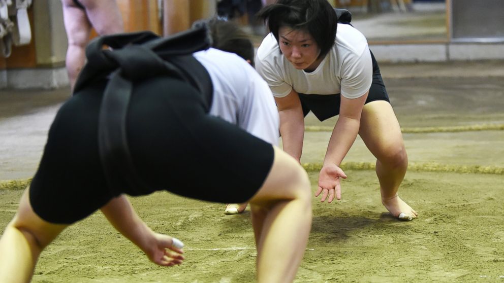 Sumo wrestler Sayaka Matsuo fights with her teammate Shiori Kanehira during a training session at Nihon University's sumo club in Tokyo on Jan. 25, 2015.