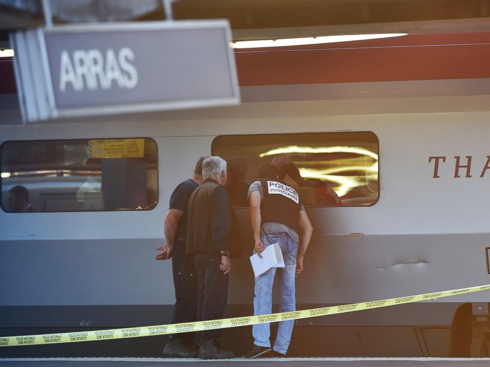 PHOTO: Crime investigators look into the window of a Thalys train at the main train station in Arras, northern France, on Aug. 21, 2015.