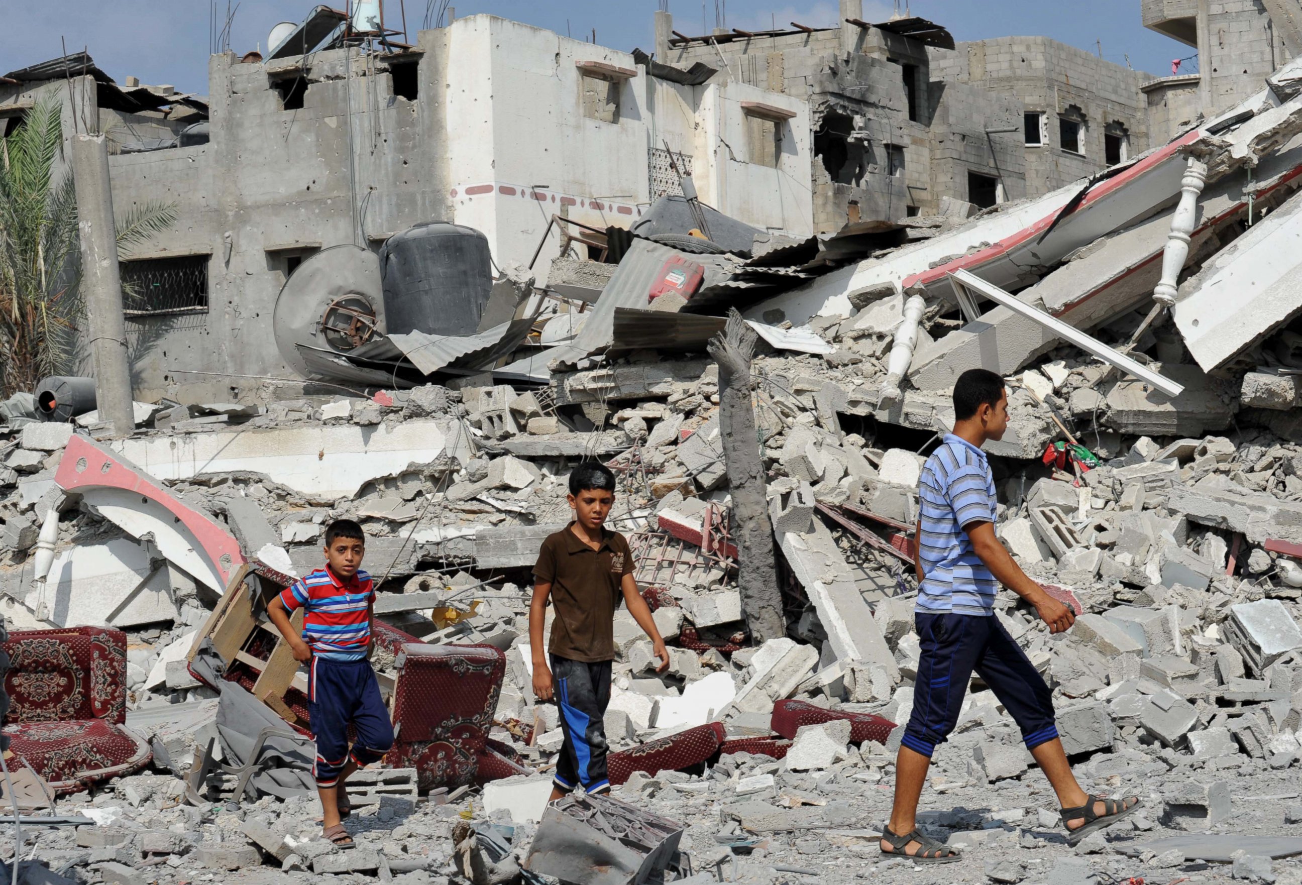 PHOTO: Palestinians try to find usable belongings at the ruins of their destroyed buildings during the 72-hour humanitarian truce in Shejaiya neighbourhood, Gaza on Aug. 5, 2014. 
