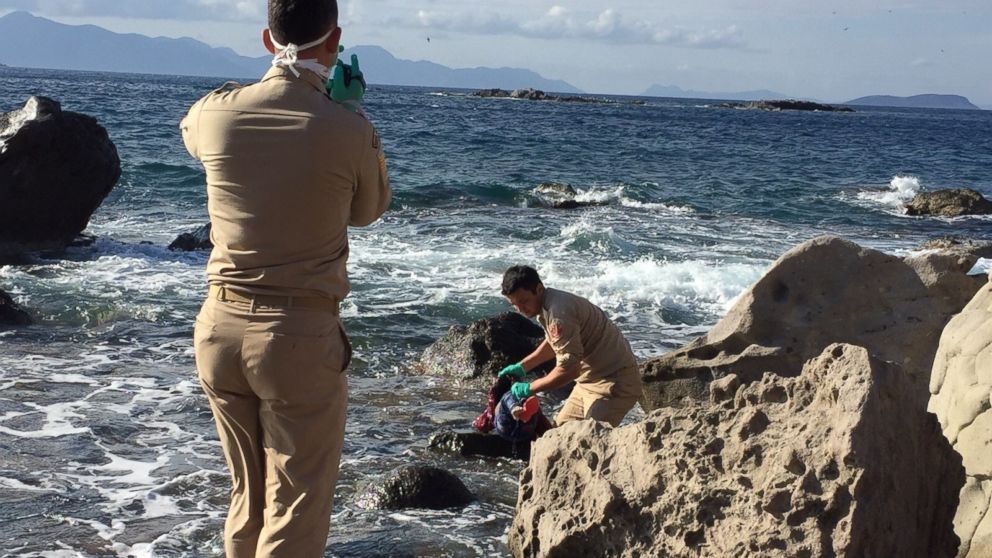 Turkish coast guards try to get the body of a refugee girl out of sea after a boat sunk during the journey to Europe, at the shores of Turkey on Nov. 22, 2015. 
