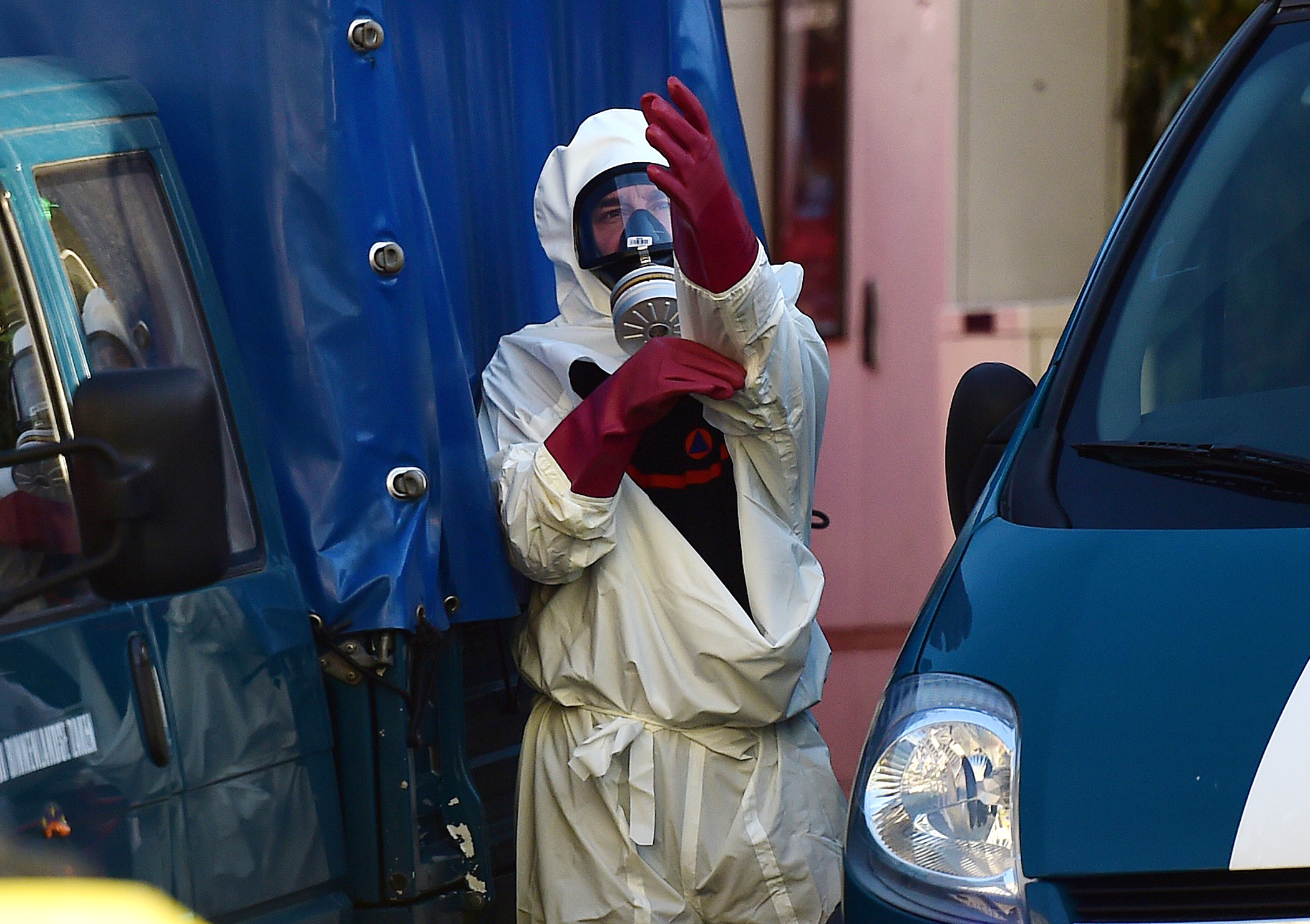 PHOTO: A decontamination unit worker suits up in front of Brussels' Great Mosque in Brussels on Nov. 26, 2015.