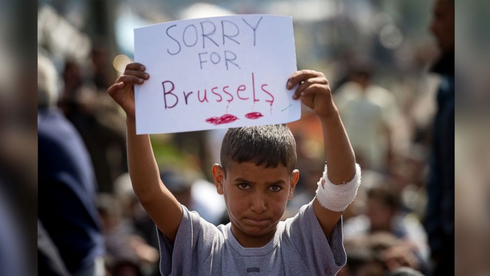 PHOTO: A boy holds a placard expressing sympathy for the victims of the terror attacks in Brussels during a protest at a makeshift camp at the Greek-Macedonian border near the village of Idomeni on March 22, 2016.