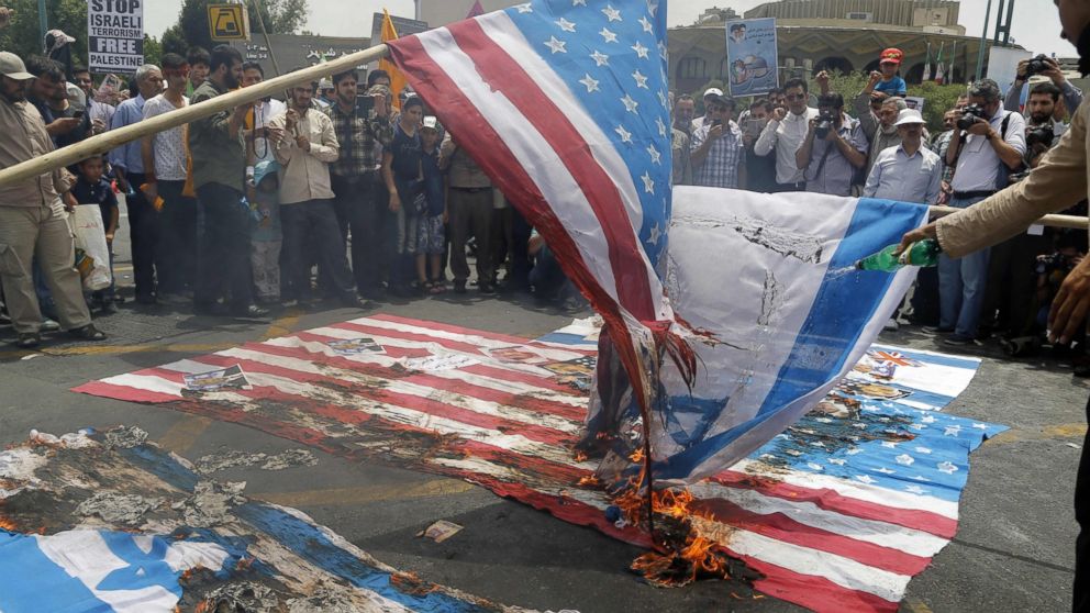 PHOTO: Iranian protestors set US and Israeli flags afire during a parade marking al-Quds (Jerusalem) Day in Tehran, July 01, 2016. Tens of thousands joined pro-Palestinian rallies in Tehran. 