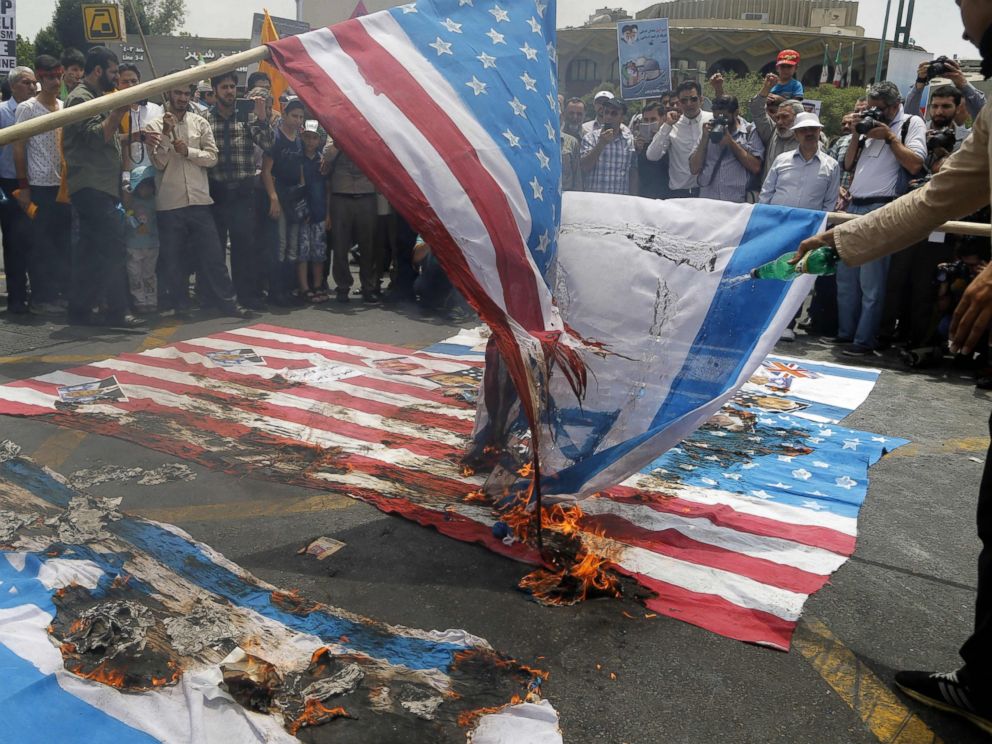 PHOTO: Iranian protestors set US and Israeli flags afire during a parade marking al-Quds (Jerusalem) Day in Tehran, July 01, 2016. Tens of thousands joined pro-Palestinian rallies in Tehran.