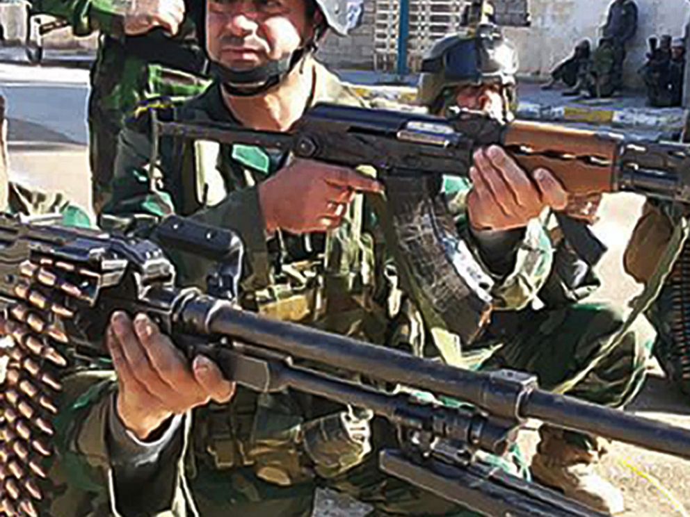 PHOTO: Iraqi soldiers take position in a street of Ramadi, west of the capital Baghdad, on Jan. 19, 2014 during a military operation against anti-government fighters.