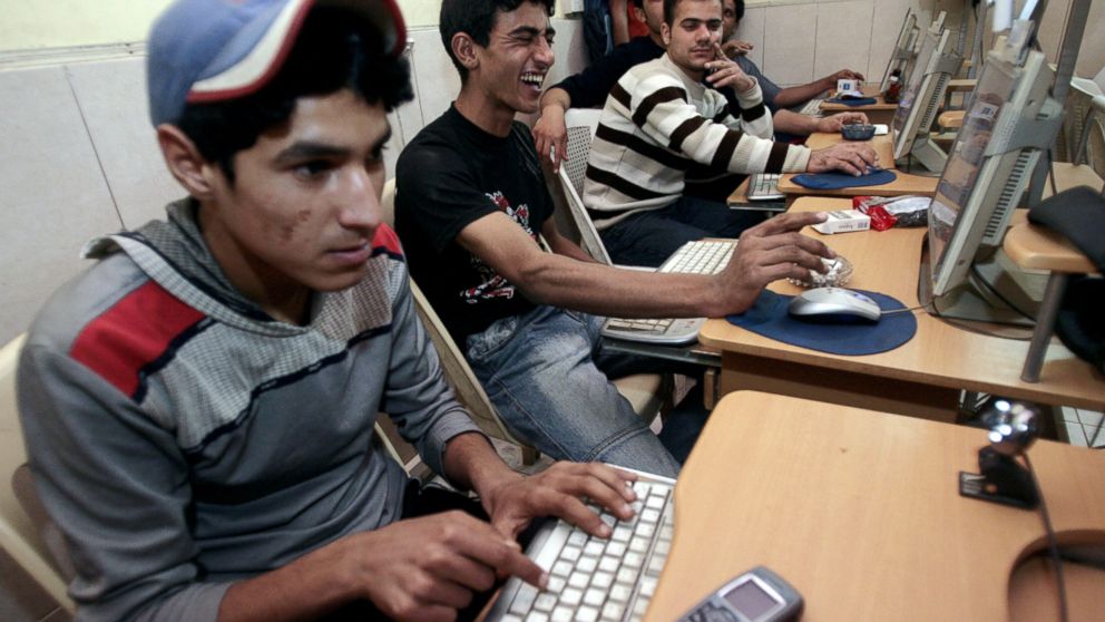 Iraqi youths surf the web at an internet cafe in Baghdad, March 19, 2008. 