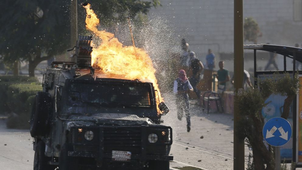 PHOTO: An Israeli security forces jeep ignites as Palestinian protesters throw a Molotove cocktail at it during clashes near the Beit El settlement on the outskirts of Ramallah in the West Bank, on Oct. 17, 2015. 