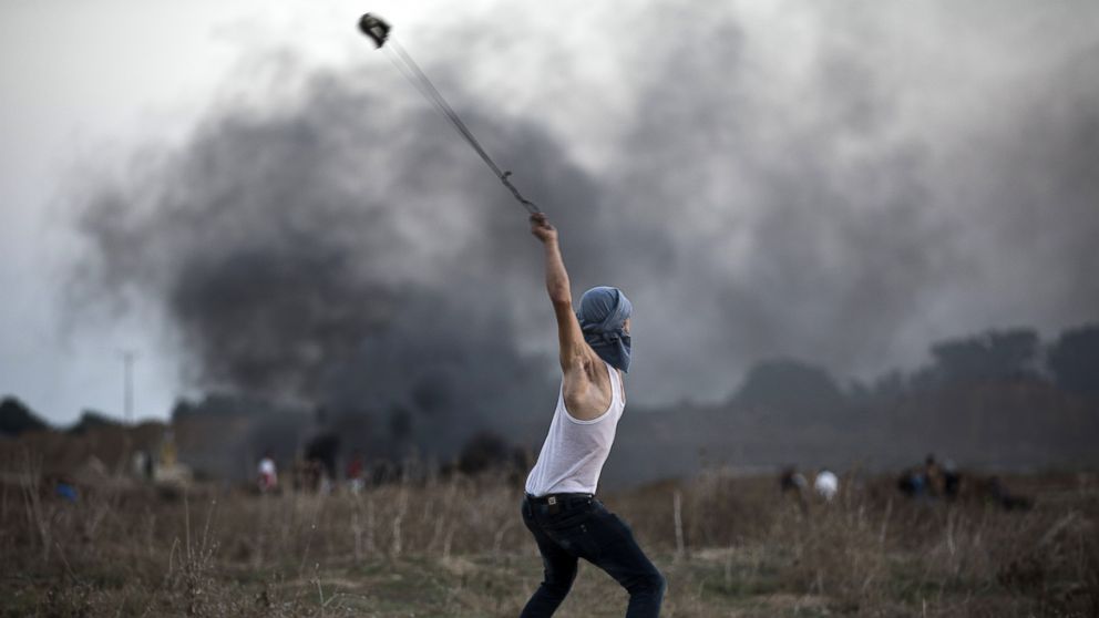 PHOTO: A Palestinian protester uses a slingshot to throw stones towards Israeli soldiers during clashes near the border fence between Israel and the central Gaza Strip east of Bureij on Oct. 15, 2015. 