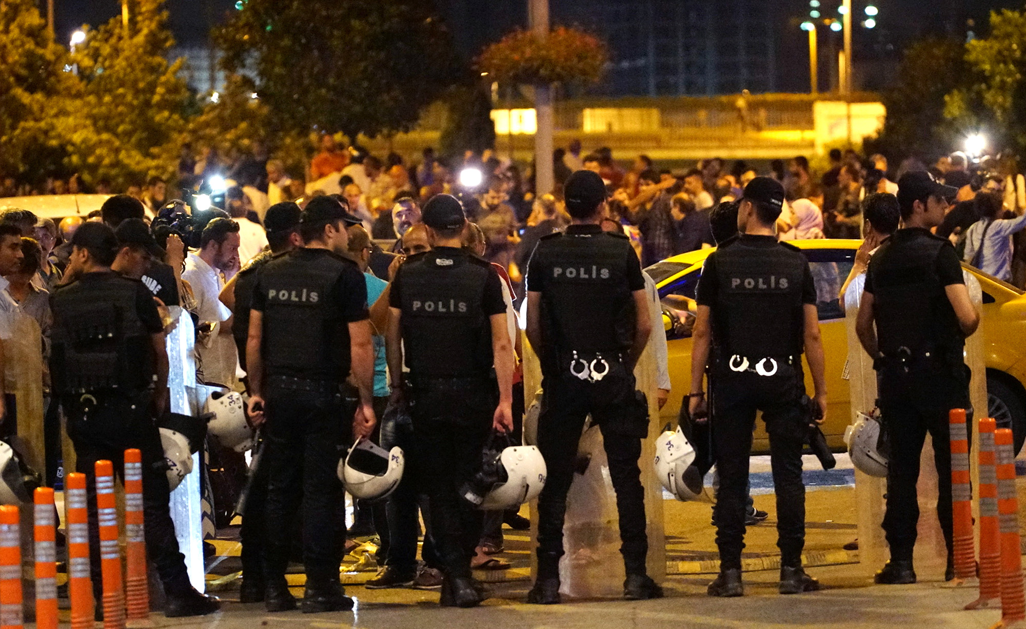 PHOTO: Turkish police blocks the road as relatives wait outside the Turkey's largest airport, Istanbul Ataturk, following the suicide bomb attack, June 28, 2016 in Istanbul, Turkey