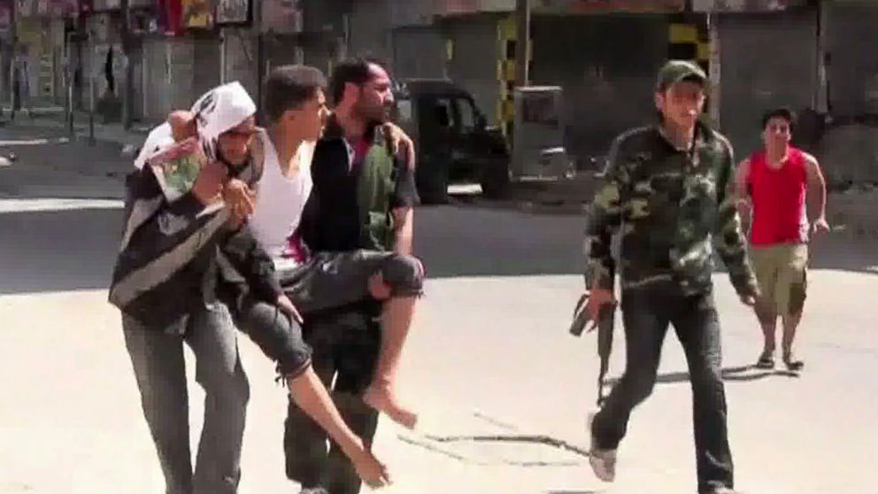 PHOTO: An image grab taken from AFP TV on August 5, 2012 shows Syrian rebels carrying a wounded man in the Salaheddin district of the northern Syrian city of Aleppo on Aug. 3, 2012.