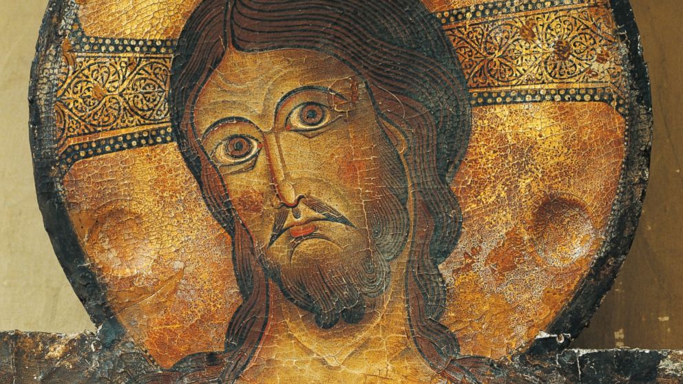 Christ's face is seen in a detail from the Crucifix, 1187, by Alberto Sotio, Cathedral of the Assumption of Mary, Spoleto, Umbria, Italy.