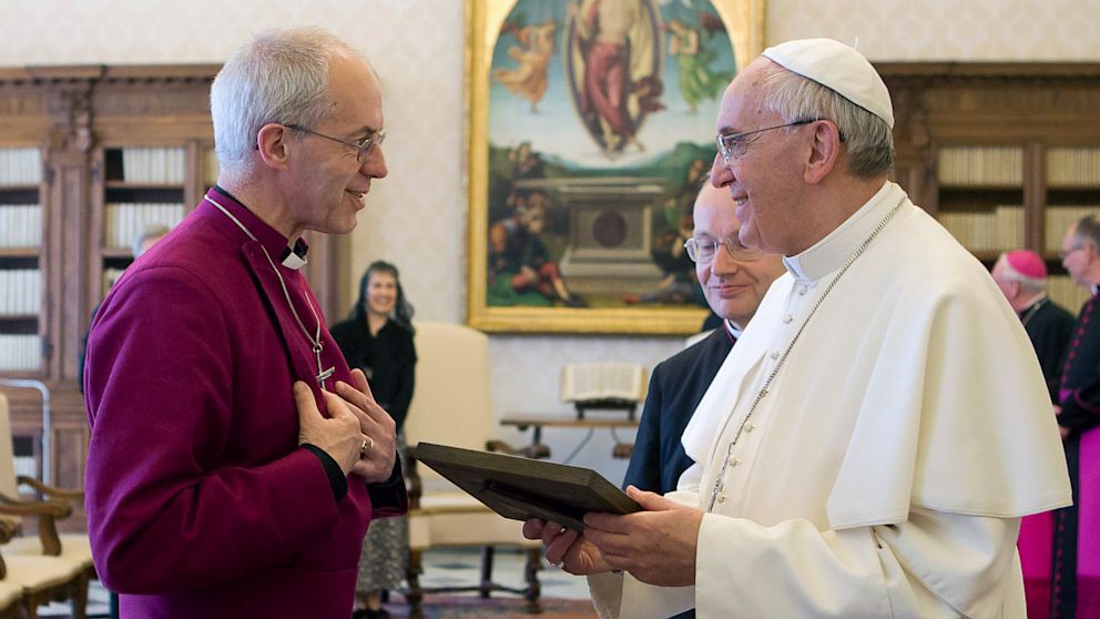 Pope Francis, right, exchanges gifts with Archbishop of Canterbury Justin Welby during a private audience at the Vatican, June 14, 2013.