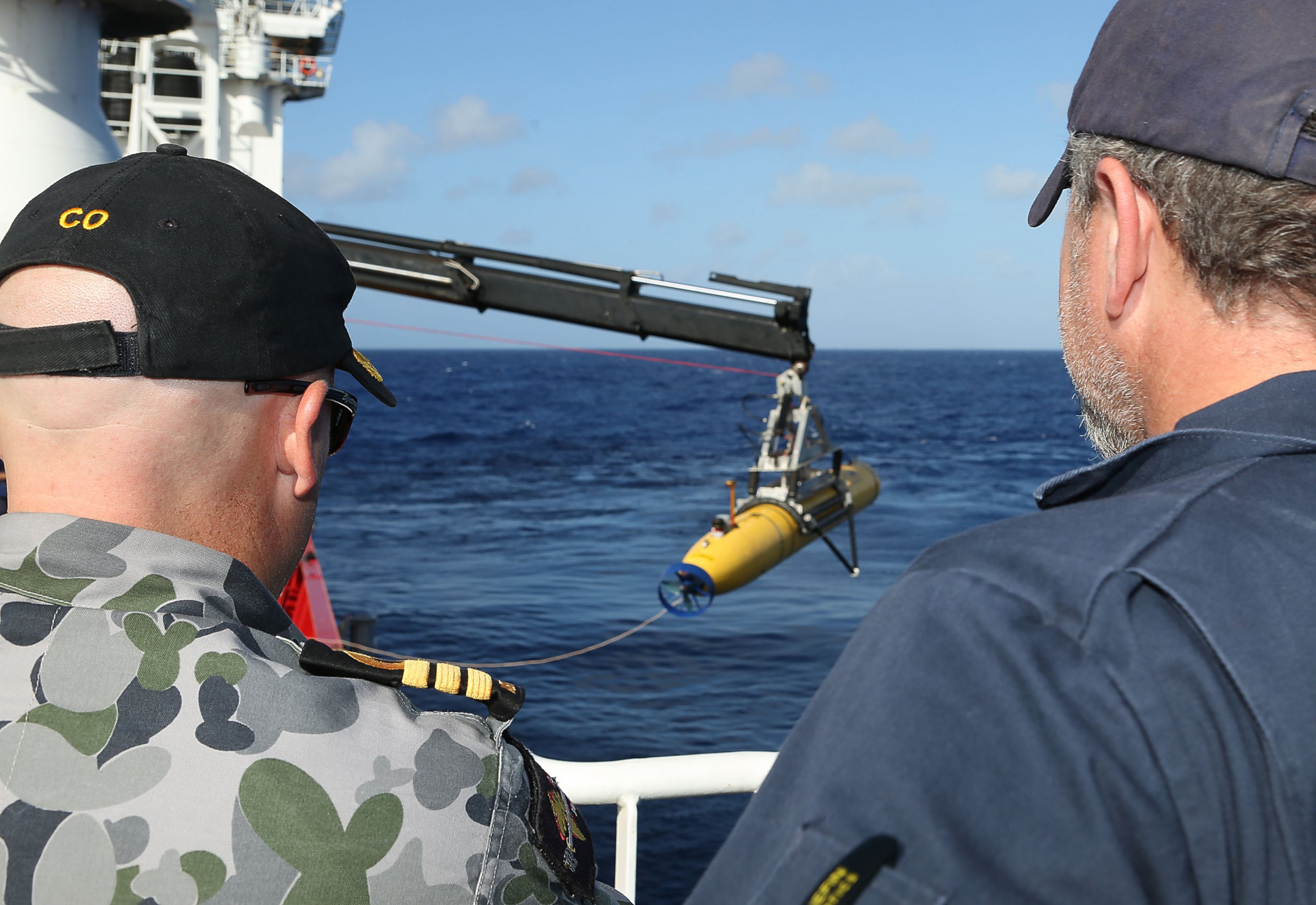 PHOTO: In this handout image provided by the Australian Department of Defense, Commander James Lybrand and Chris "Sharkie" Moore, watch the launching the Phoenix Autonomous Underwater Vehicle  Artemis off the deck of ADV Ocean Shield on April 17, 2014.
