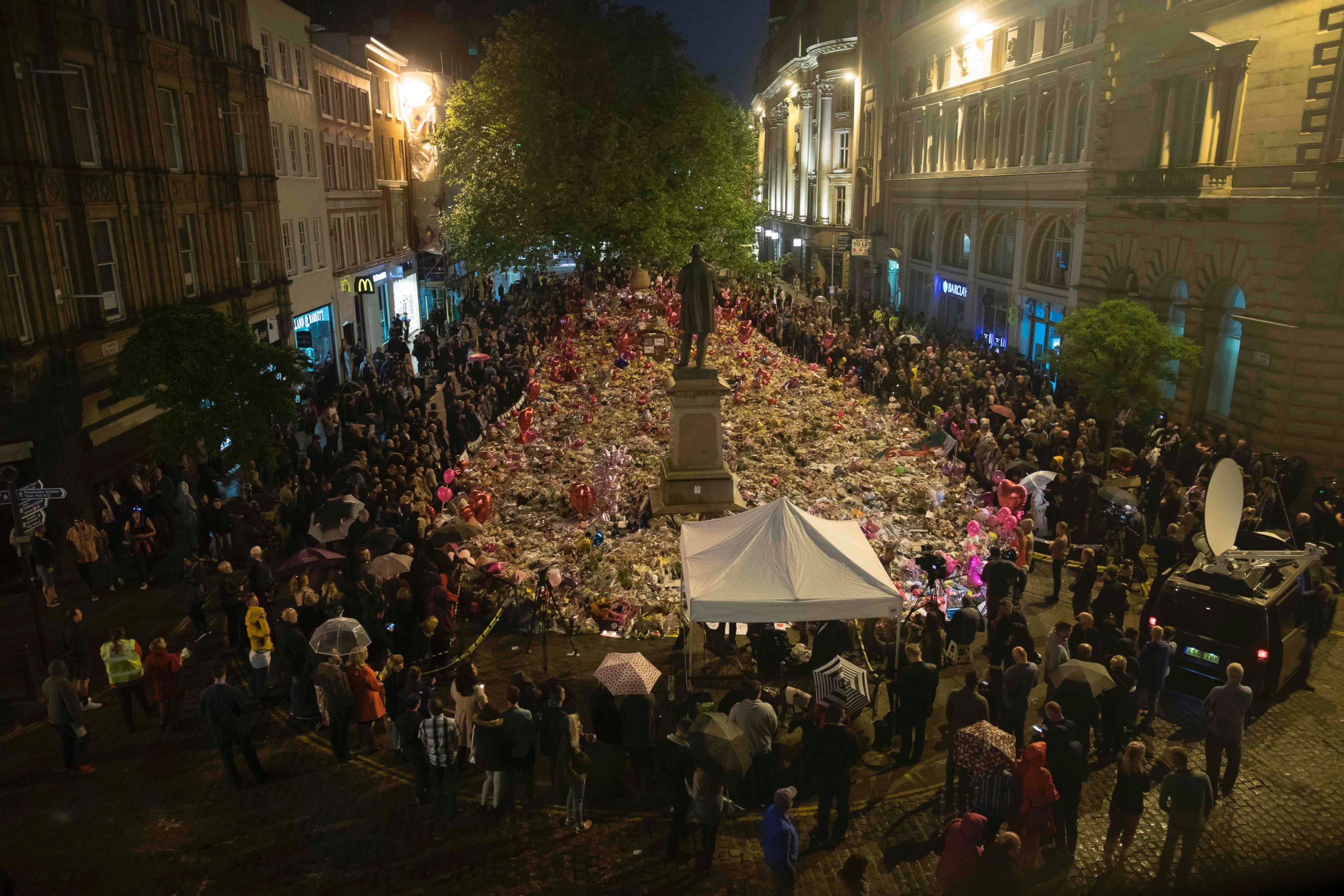 PHOTO: Members of the public take part in a vigil on St. Ann's Square in Manchester, northwest England on May 29, 2017, exactly one week after a bomb attack at Manchester Arena killed 22 and injured dozens more. 
