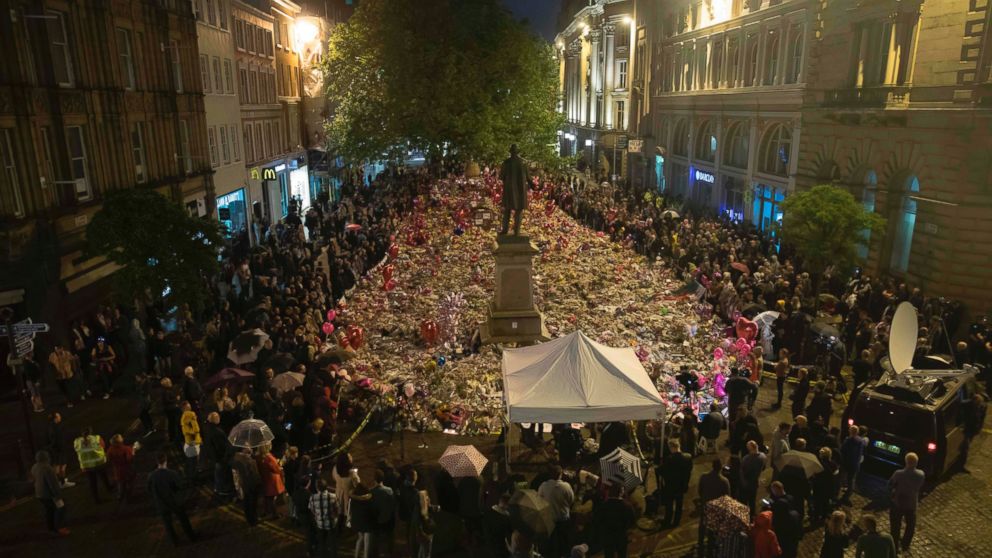 PHOTO: Members of the public take part in a vigil on St. Ann's Square in Manchester, northwest England on May 29, 2017, exactly one week after a bomb attack at Manchester Arena killed 22 and injured dozens more. 

