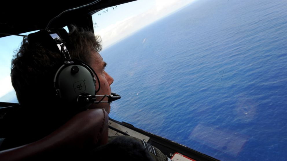 PHOTO: Co-pilot and Squadron Leader Brett McKenzie of the Royal New Zealand Airforce P-3K2-Orion aircraft, helps to look for objects during the search for missing flight MH370 in flight over the Indian Ocean off the coast of Perth, Australia. 