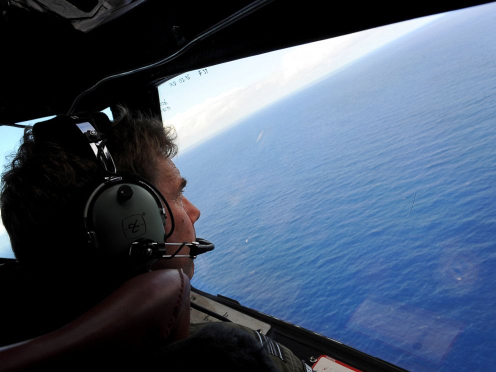 PHOTO: Co-pilot and Squadron Leader Brett McKenzie of the Royal New Zealand Airforce P-3K2-Orion aircraft, helps to look for objects during the search for missing flight MH370 in flight over the Indian Ocean off the coast of Perth, Australia.