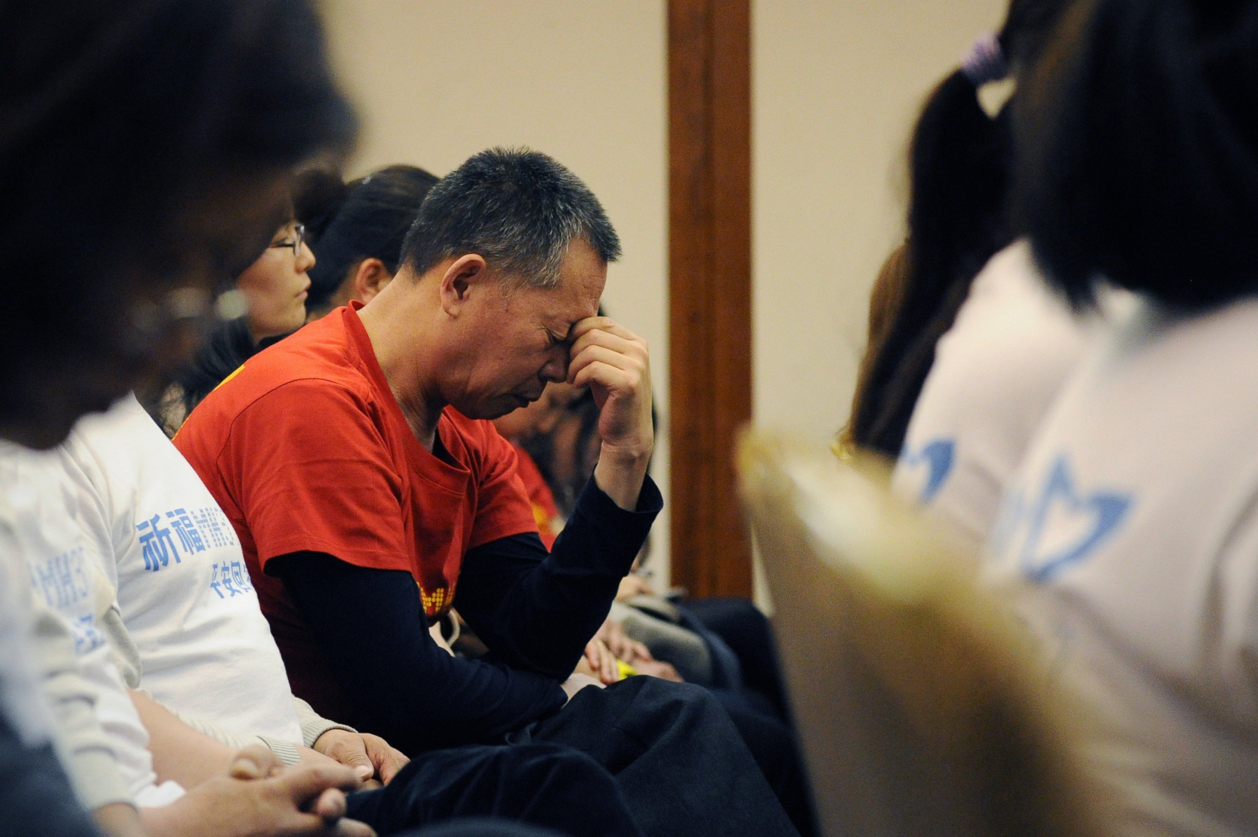 PHOTO: A man reacts as Chinese relatives of passengers on the missing Malaysia Airlines flight MH370 attend a meeting at the Metro Park Hotel in Beijing on April 21, 2014. 