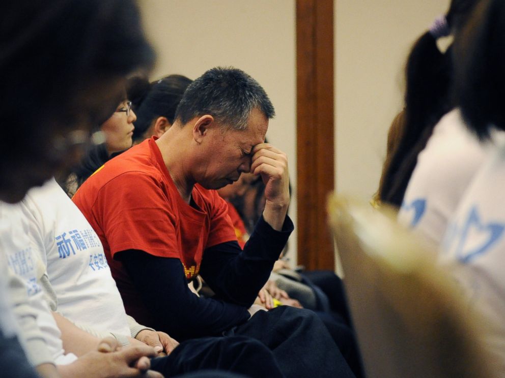 PHOTO: A man reacts as Chinese relatives of passengers on the missing Malaysia Airlines flight MH370 attend a meeting at the Metro Park Hotel in Beijing on April 21, 2014.