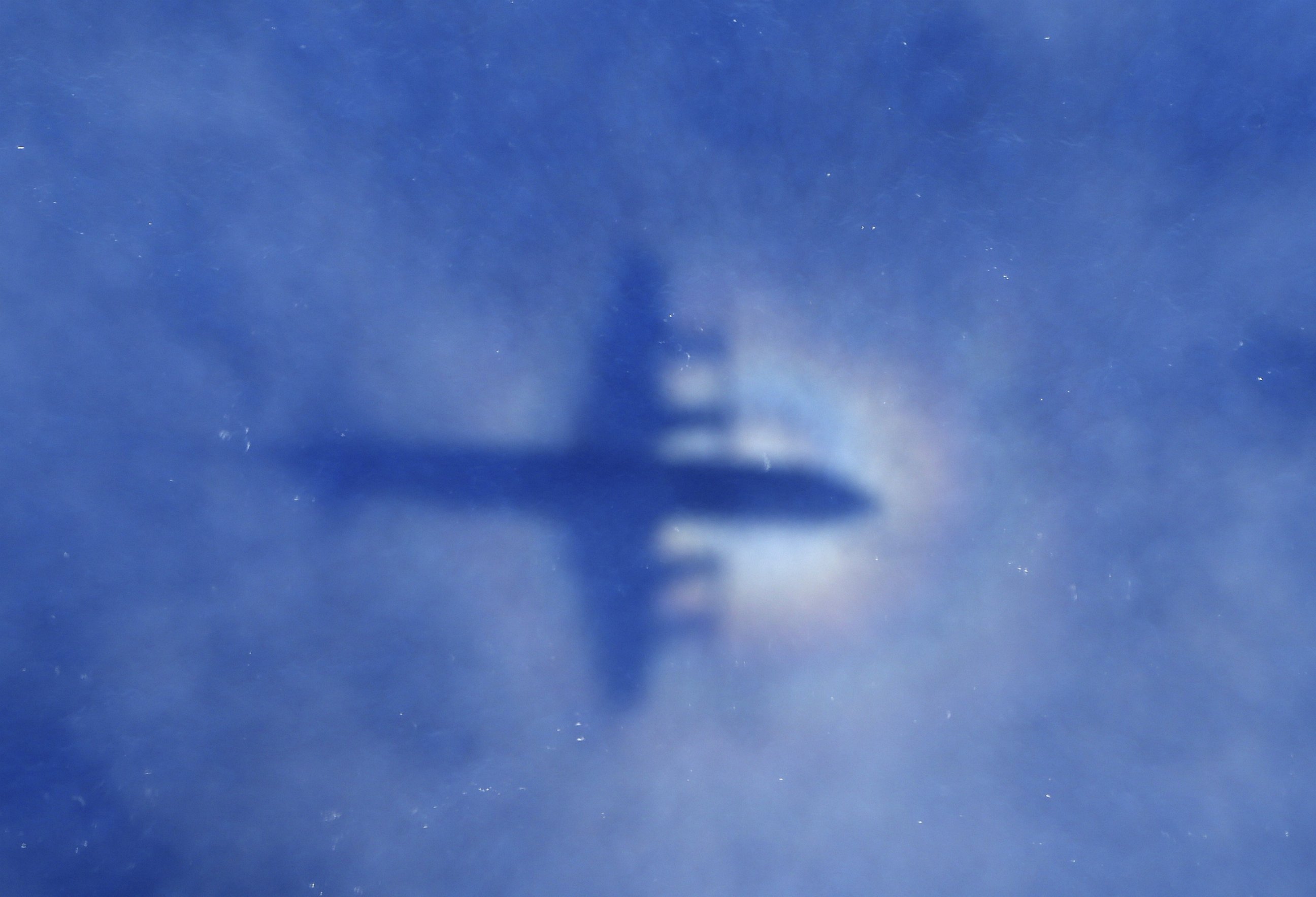 PHOTO: This shadow of a Royal New Zealand Air Force P3 Orion aircraft is seen on low cloud cover while it searches for missing Malaysia Airlines flight MH370, over the Indian Ocean on March 31, 2014.