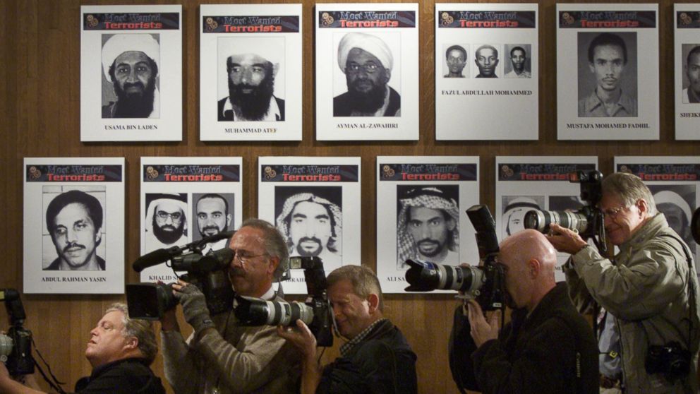 PHOTO: Members of the media stand next to a wall of the Most Wanted terrorists as U.S. President George W. Bush announces a new list of the FBI's Most Wanted, placing Osama Bin Laden is at the top of the list Oct. 10, 2001 in Washington, D.C.