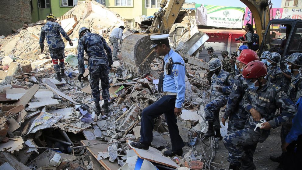 Nepalese security forces inspect the debris of a five-story building in Balaju neighborhood of Kathmandu after a magnitude 7.3 earthquake hit Nepal on May 12, 2015.