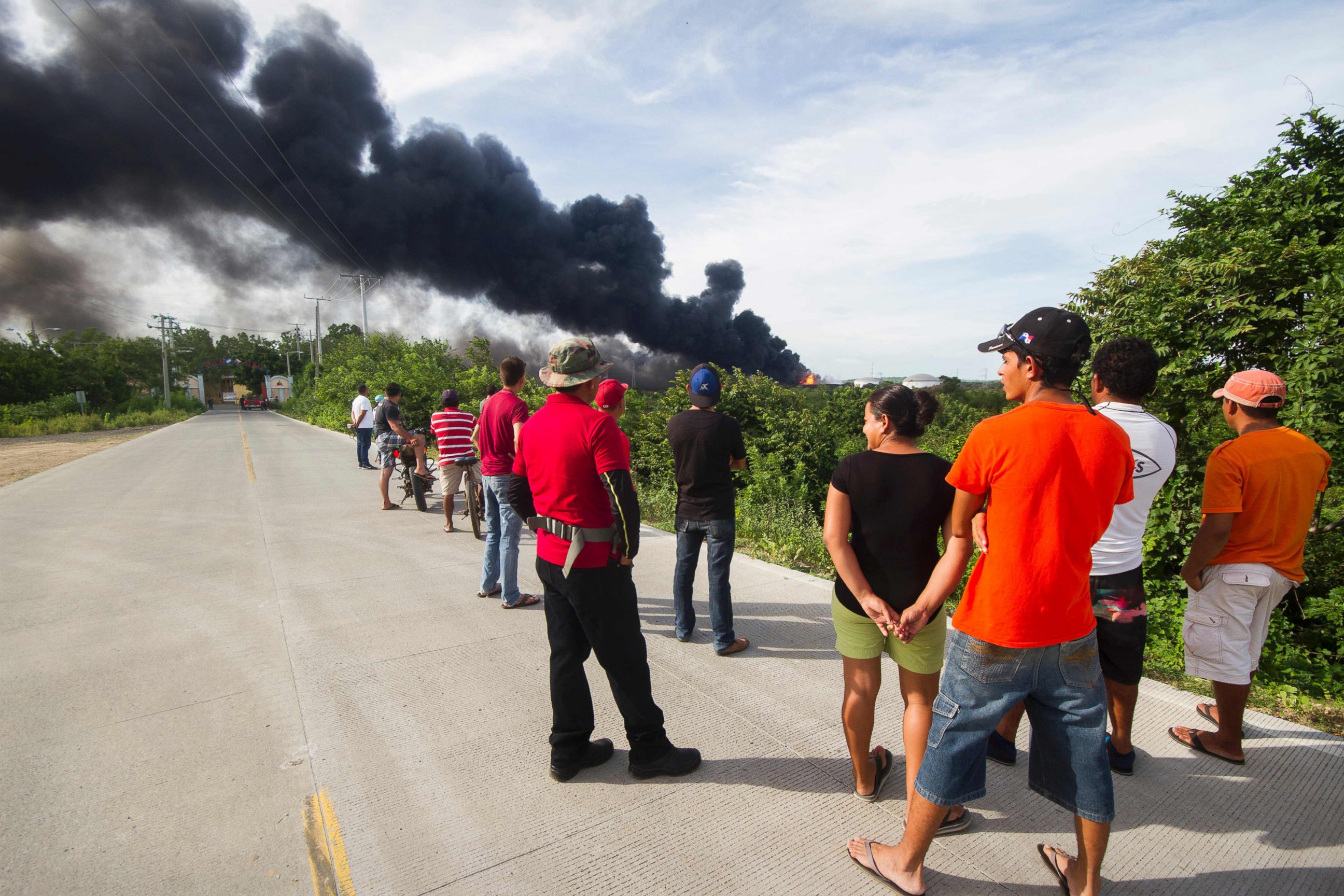 PHOTO: Residents watch as fire burns following the explosion of a second fuel storage tank at the Puma Energy plant in Puerto Sandino, northwest of Managua, on August 18, 2016.