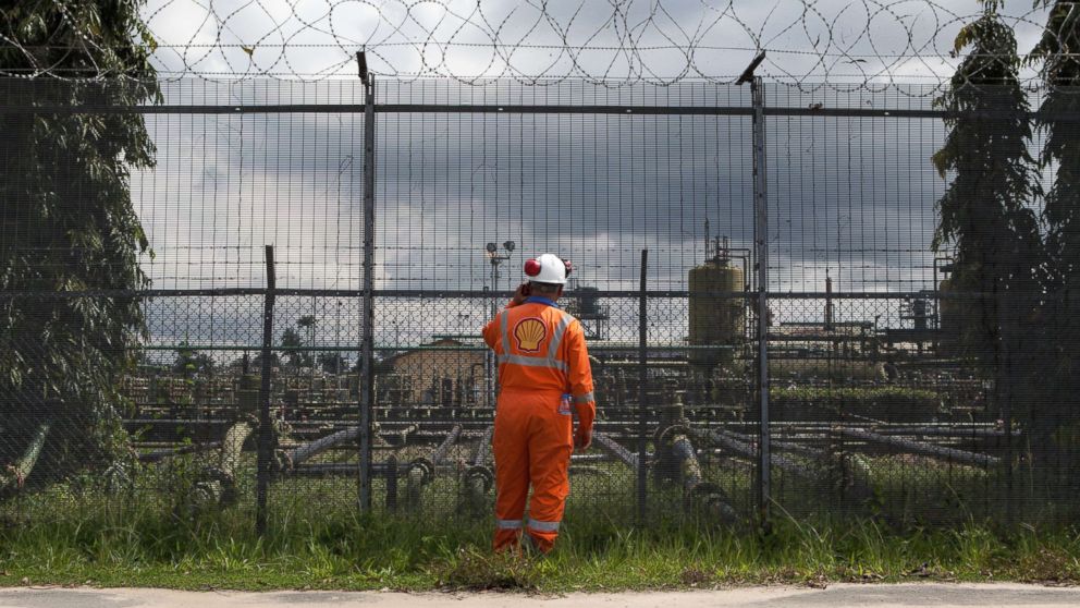 PHOTO: An employee at the Shell Agbada 2 flow station talks on a walkie-talkie at the entrance of the station in Port Harcourt on Sept. 30, 2015.