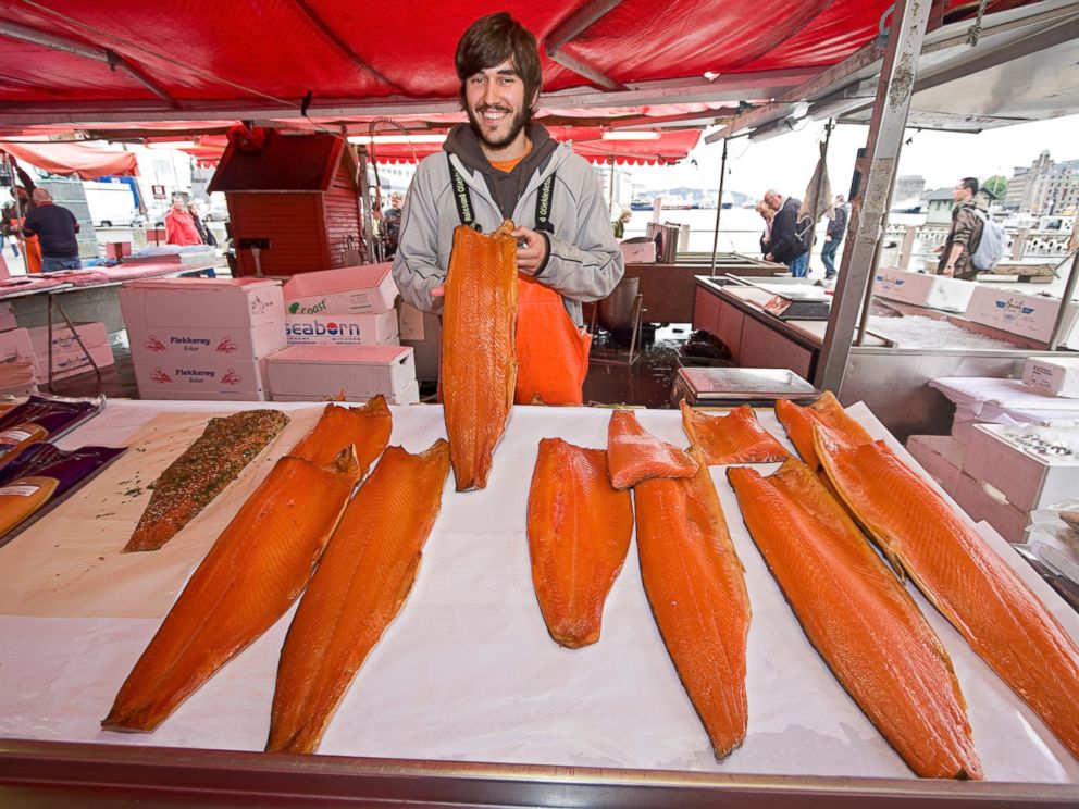 PHOTO: A man offers salmon for sale at the waterfront fish market in Bergen, Norway.