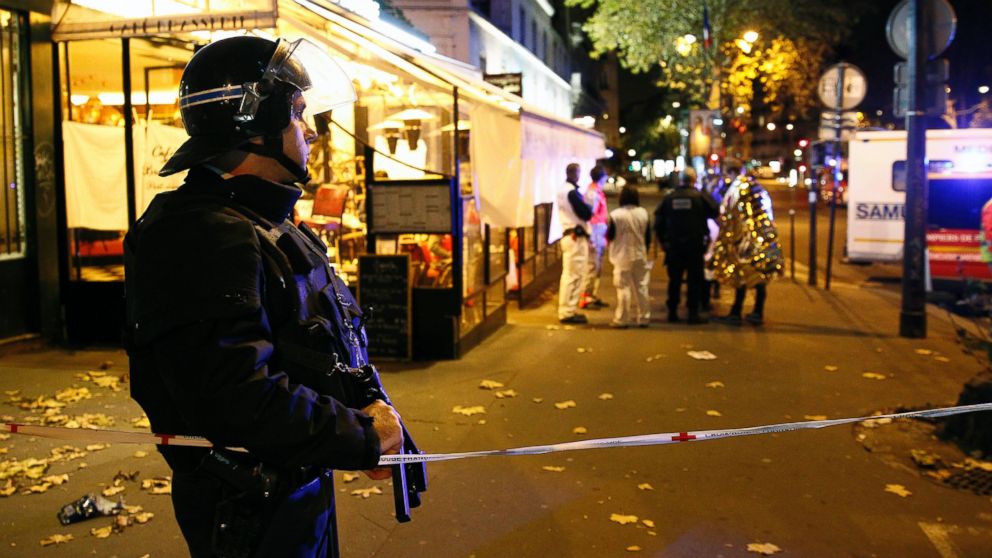 A policeman stands guard near the Boulevard des Filles-du-Calvaire after an attack, Nov, 13, 2015 in Paris.