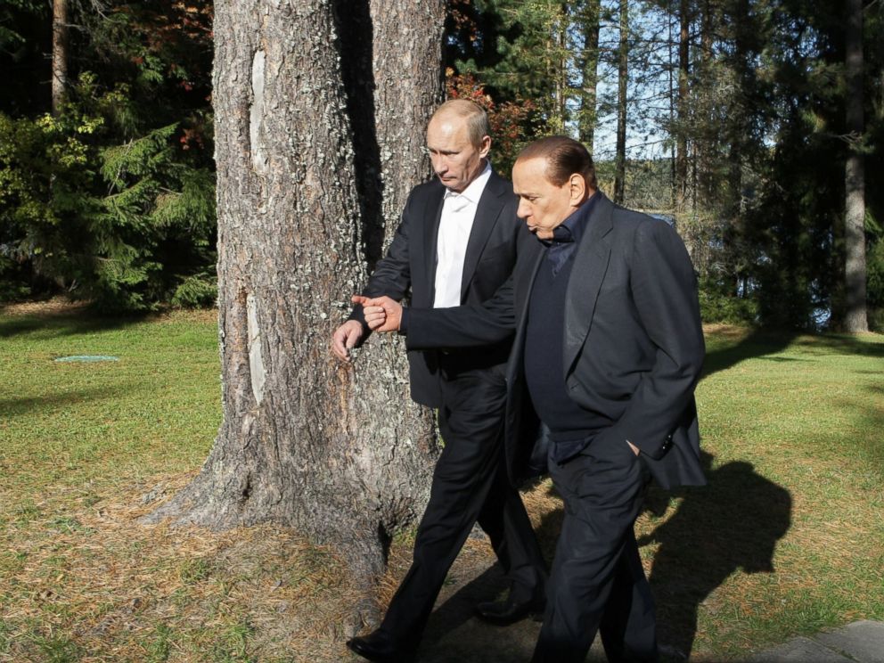 PHOTO: Russian Prime Minister Vladimir Putin (L) walks with his Italian counterpart Silvio Berlusconi in Saint Petersburg on October 9, 2010.