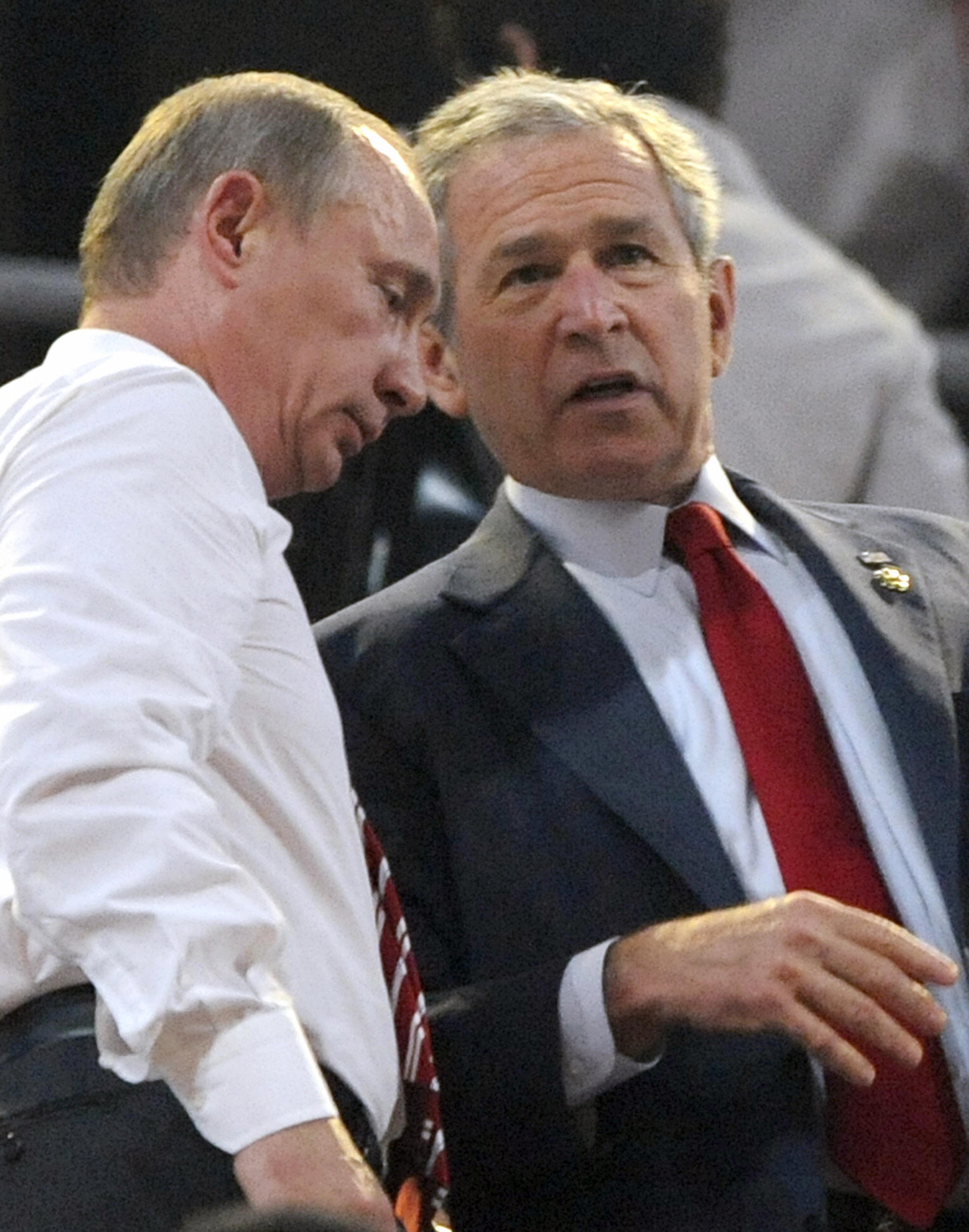PHOTO: Russian Prime Mininster Vladimir Putin (L) talks with US President George W. Bush at the start of the opening ceremony of the 2008 Beijing Olympic Games in Beijing on August 8, 2008. 