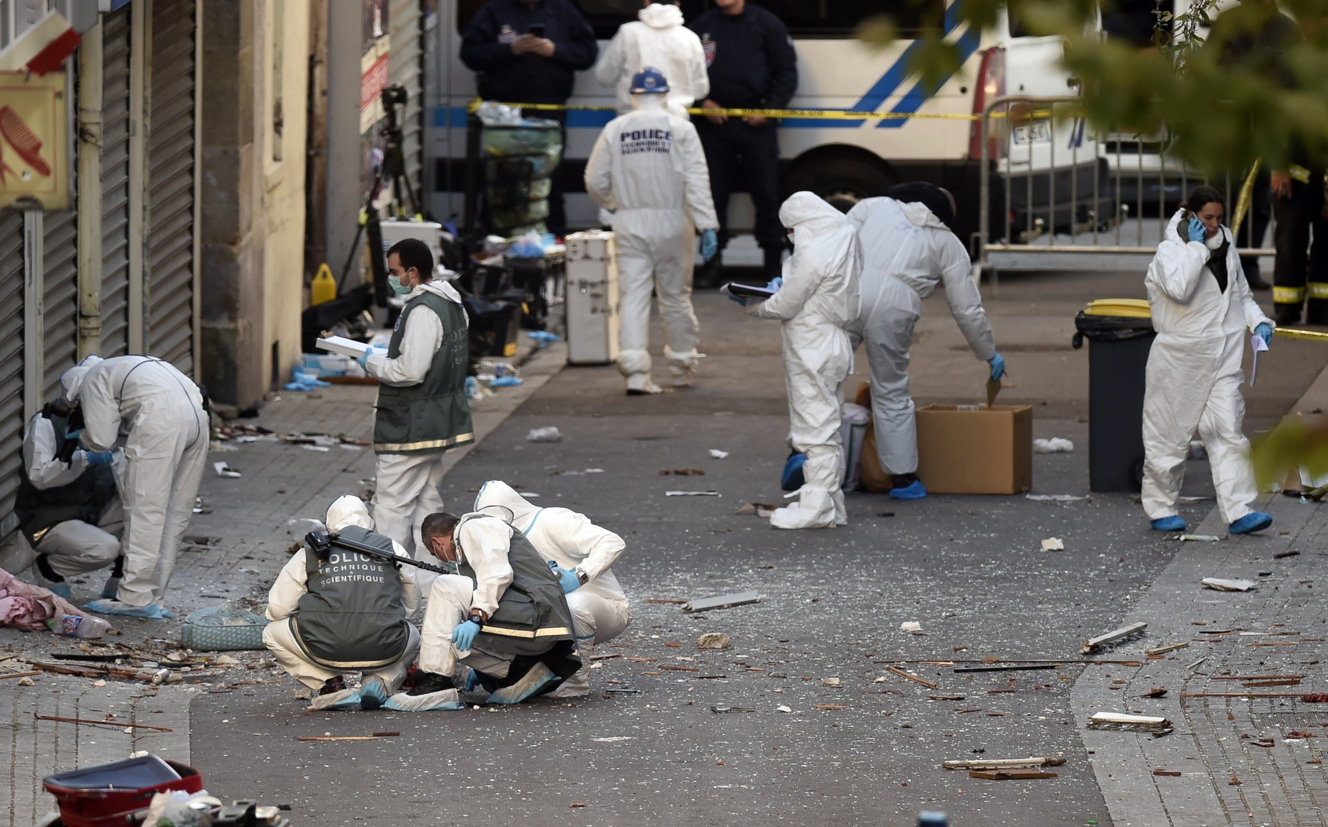 PHOTO: Forensic investigators search for evidence outside the apartment building that was raided by French Police in Saint-Denis, France, Nov. 18, 2015.