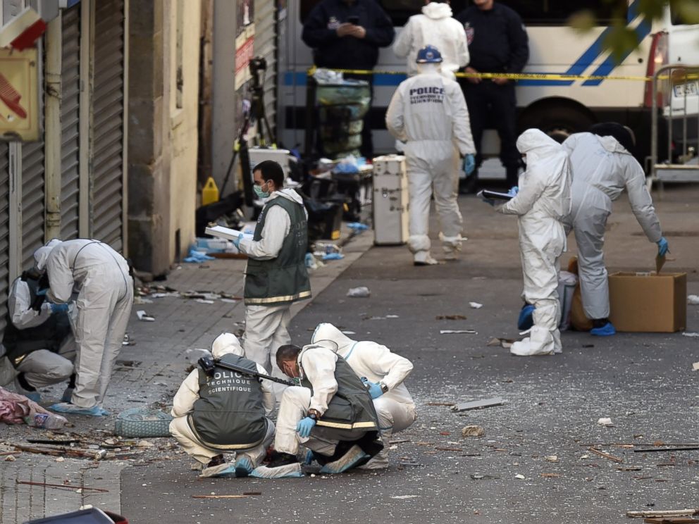 PHOTO: Forensic investigators search for evidence outside the apartment building that was raided by French Police in Saint-Denis, France, Nov. 18, 2015.