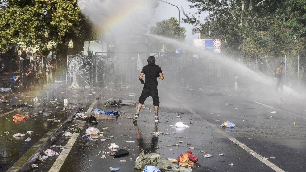 Refugee Crisis Riot Police Use Tear Gas Water Cannons In Hungary Abc News 