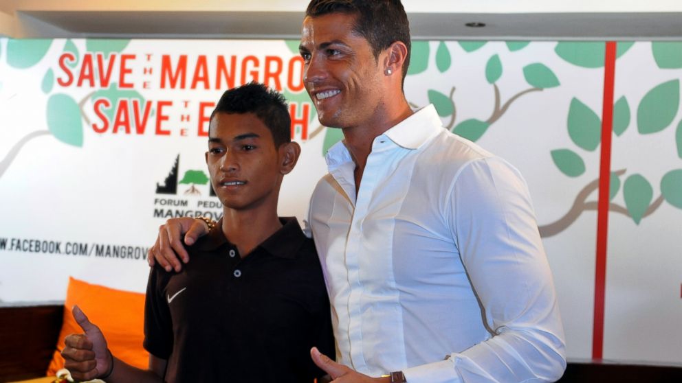 Football player Cristiano Ronaldo, right, is reunited with Martunis, left, an Indonesian survivor of the deadly 2004 Aceh tsunami who the Real Madrid star met in 2005 during a mission to assist tsunami victims and gave his family financial assistance. 