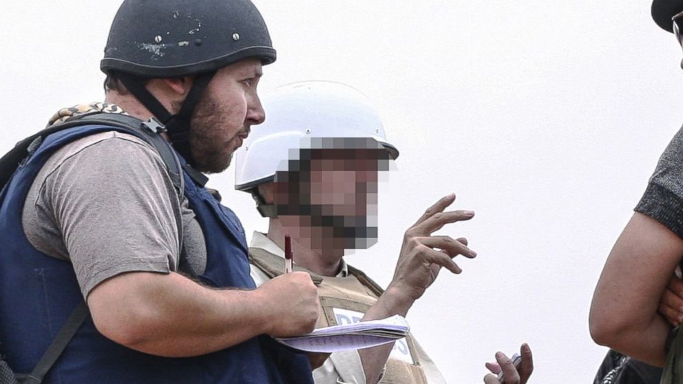 In this handout image made available by the photographer Etienne de Malglaive, American journalist Steven Sotloff (center with black helmet) talks to Libyan rebels on the Al Dafniya front line, June 2, 2011 in Misrata, Libya.  