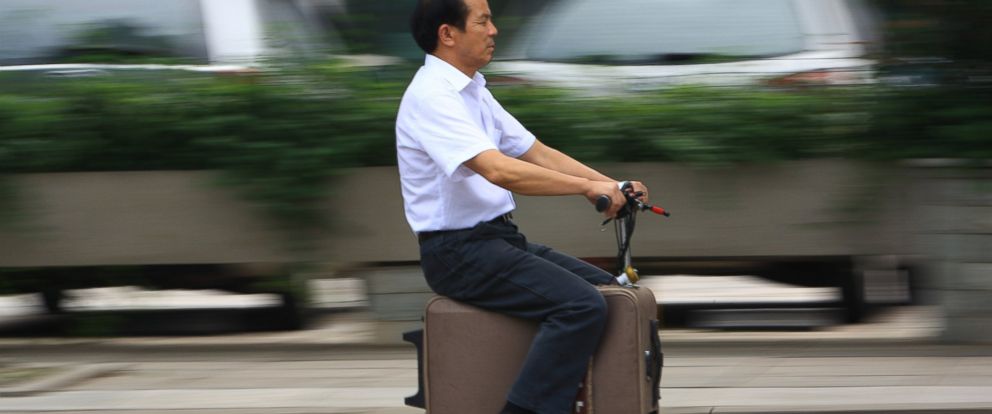Chinese Inventor Gets Around On Suitcase Scooter Abc News Chinese Inventor Gets Around On Suitcase Scooter