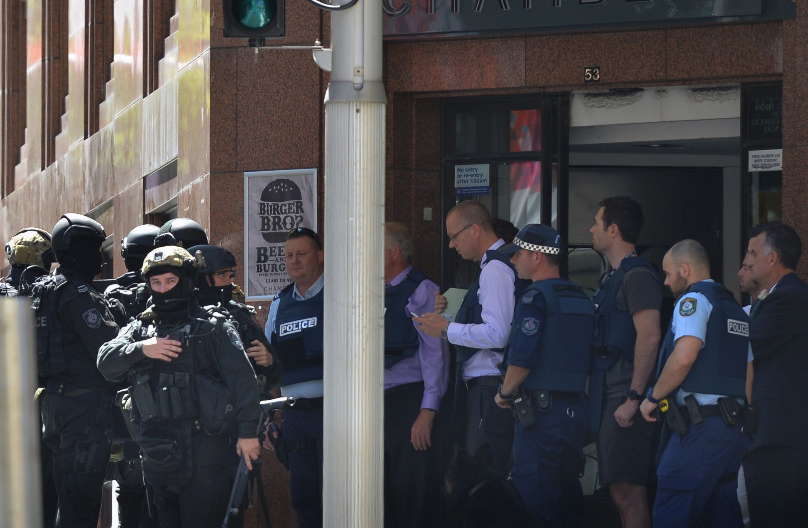 PHOTO: Armed police are seen outside a cafe in the central business district of Sydney on Dec. 15, 2014.  